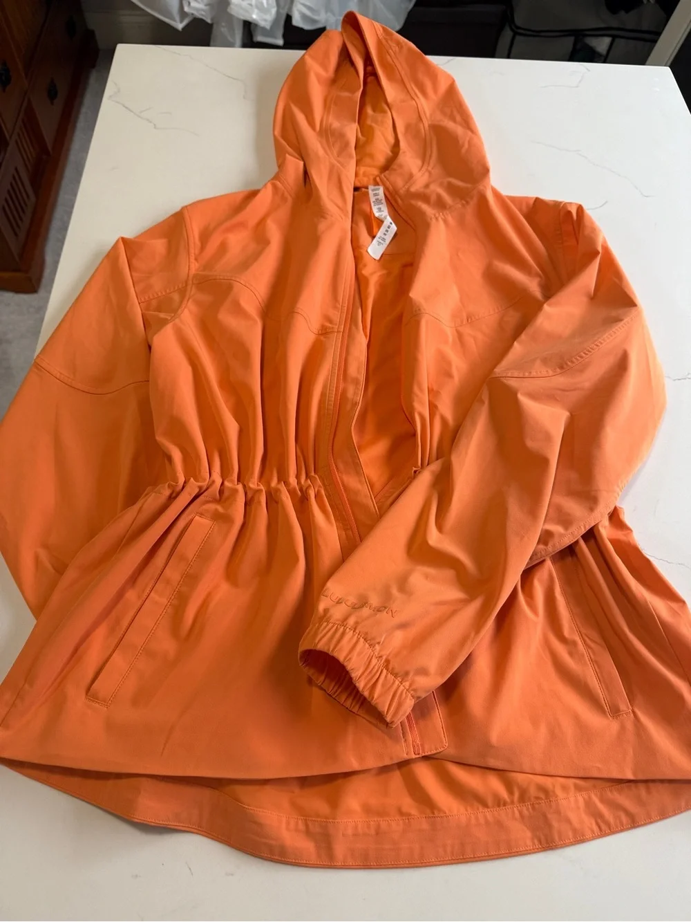 Lululemon hooded wind/rain jacket. Worn once, beautiful orange/peach color.